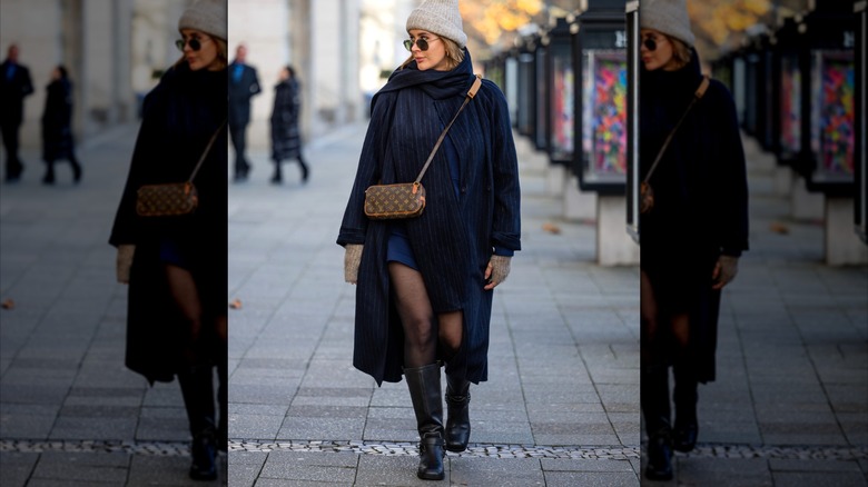 Victoria Scheu wearing winter layers and tall boots