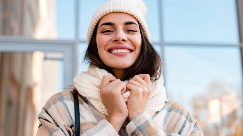 Woman wearing cream scarf and winter hat