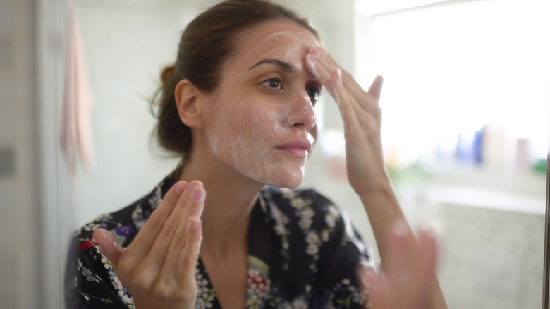 woman washing her face