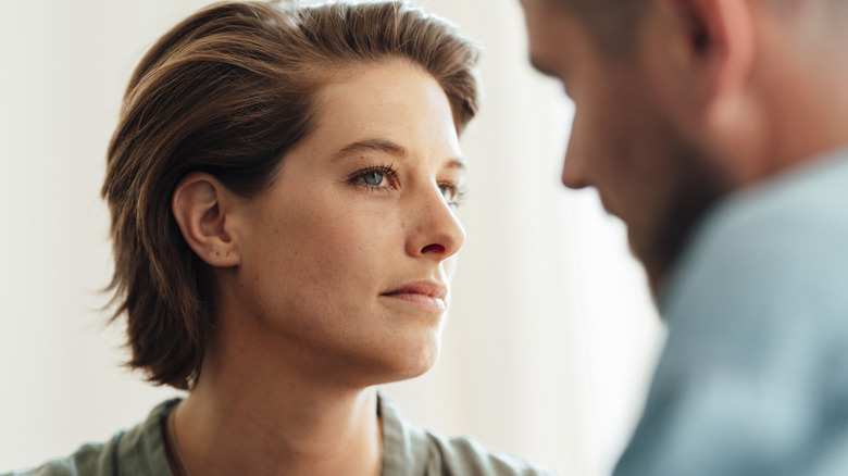 A woman looking at a man suspiciously.