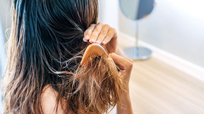 Person combing wet hair