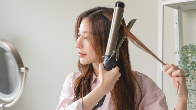 Woman curling hair