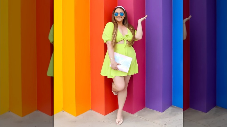 Neon yellow top and skirt rainbow background