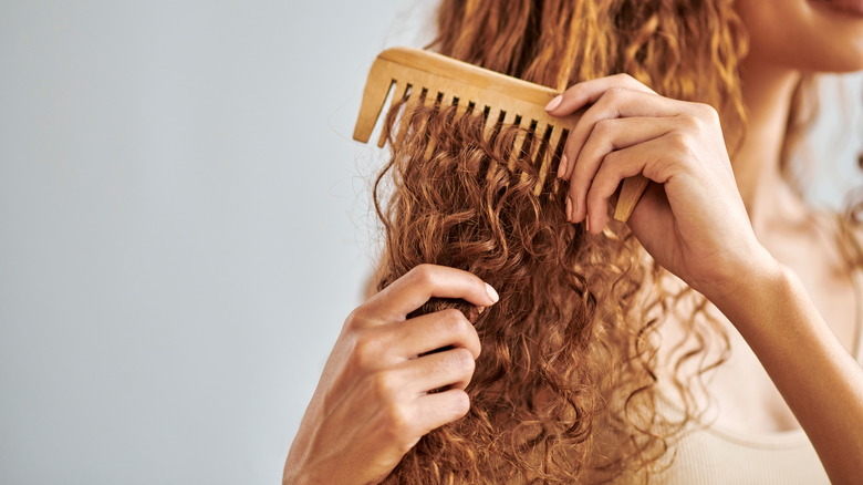 Woman combing dry hair