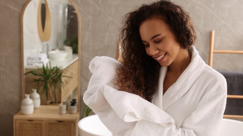 Woman drying hair using towel