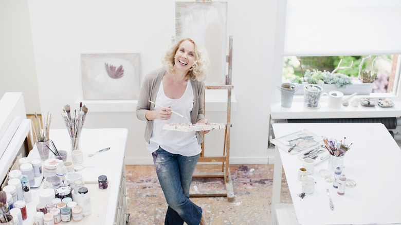 Woman stands in art studio