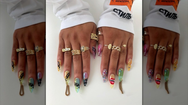 Person with maximalist chain nails