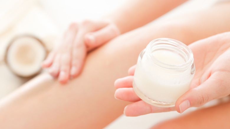 woman applying coconut oil