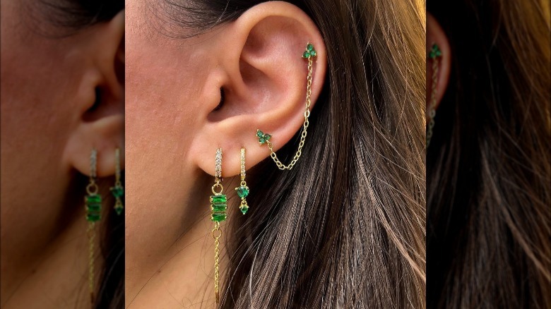 ear piercings with green gemstones