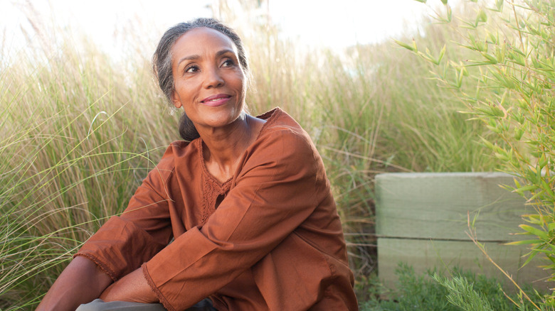 Woman smiling and sitting outside