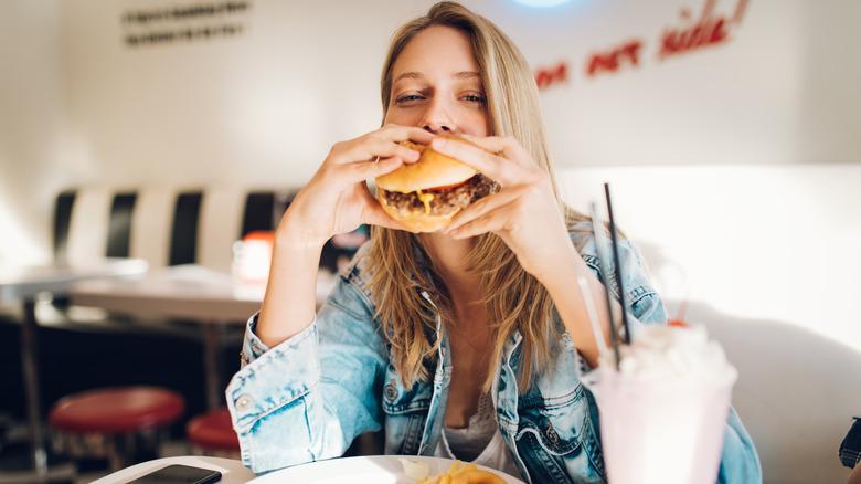 A woman eating a burger