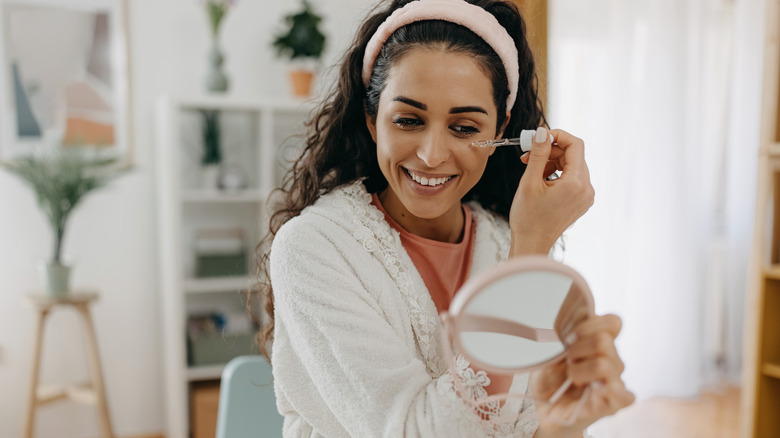 Woman applying peptide serum