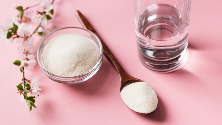 Collagen powder pictured alongside blossoms and water