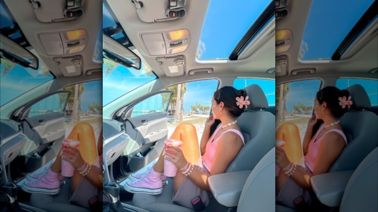 Girl sitting in a car while wearing a pink outfit.