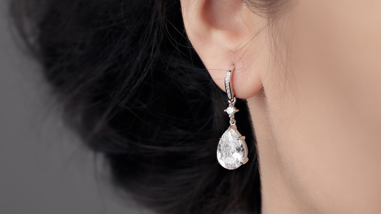 Girl wearing teardrop earrings.