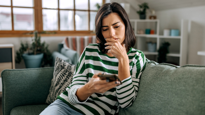 stressed woman looking at phone