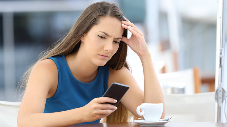 woman stood up at cafe