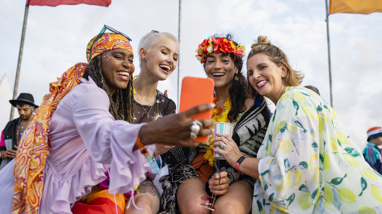 Friends taking selfie at concert