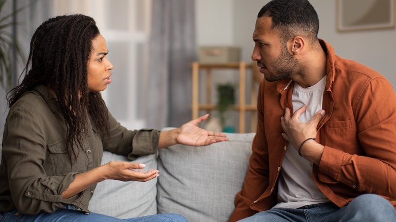 couple arguing on couch