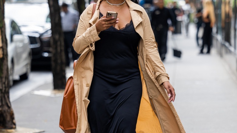 Woman wearing trench coat over dress
