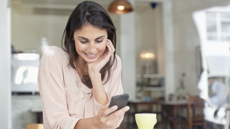 woman smiling at phone 