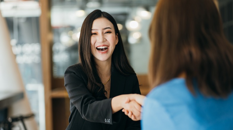 women shaking hands 