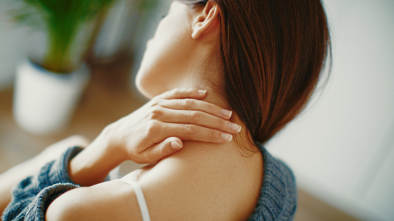 Woman massaging her neck