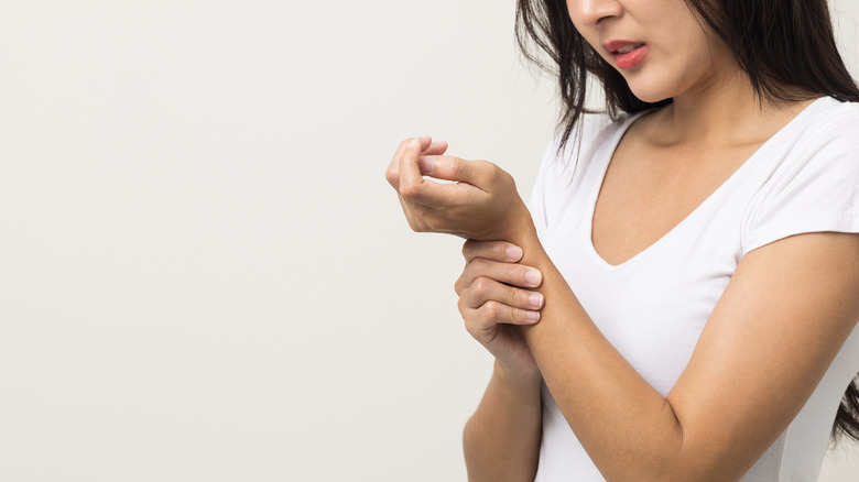 Woman massaging her forearm