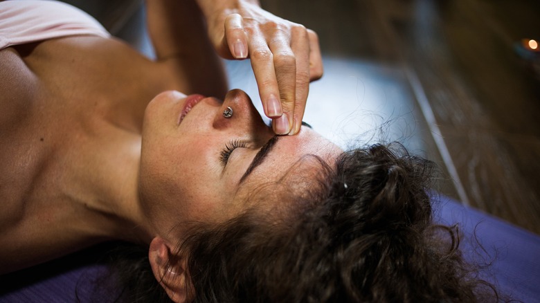 Woman applying pressure to forehead