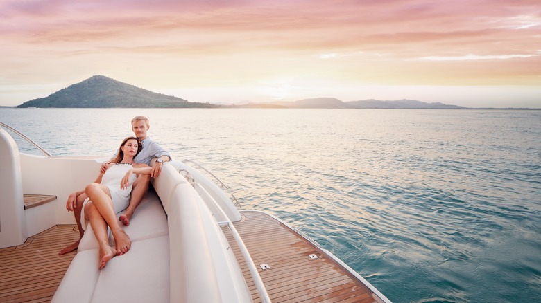 couple on yacht island sunset 