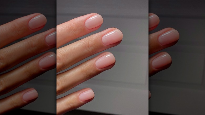 person with glossy pink nails 