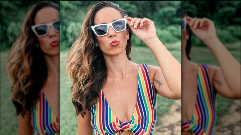 Woman wearing rainbow striped top