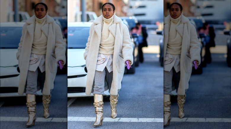 Woman wearing slouchy gold boots