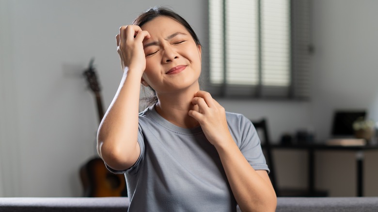 woman scratching dry skin