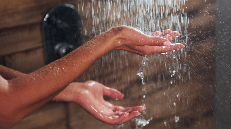 woman's hands in the shower