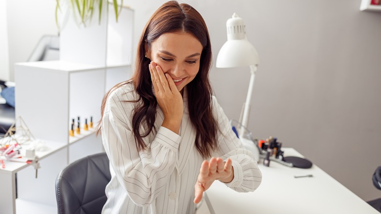 woman examining natural nails