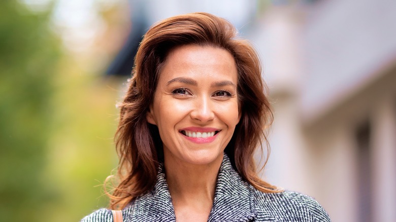 Woman with auburn hair smiling