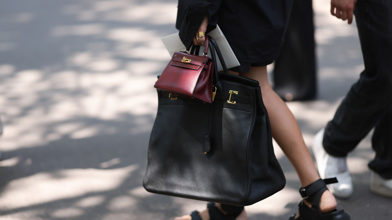 woman holding two totes