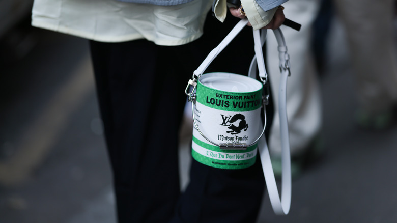 woman holding bucket bag