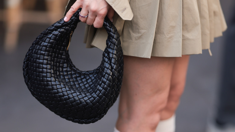 woman holding croc bag