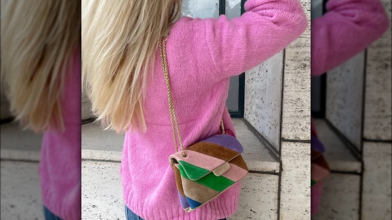 Blonde woman with suede bag