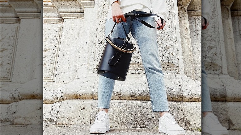 Woman holding bucket bag