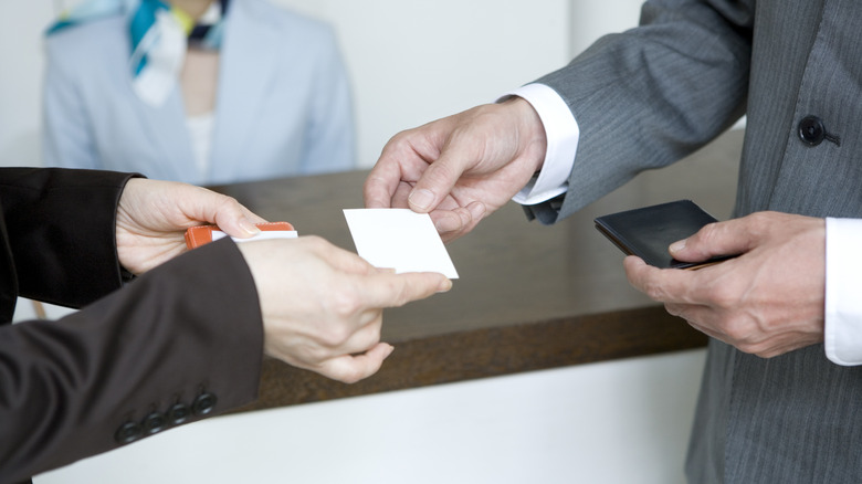 person handing out business card