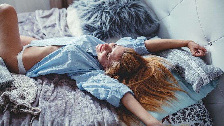 Woman in bed wearing shirt and seamless panties