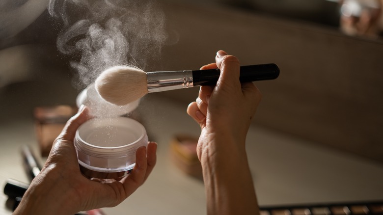 woman tapping loose powder