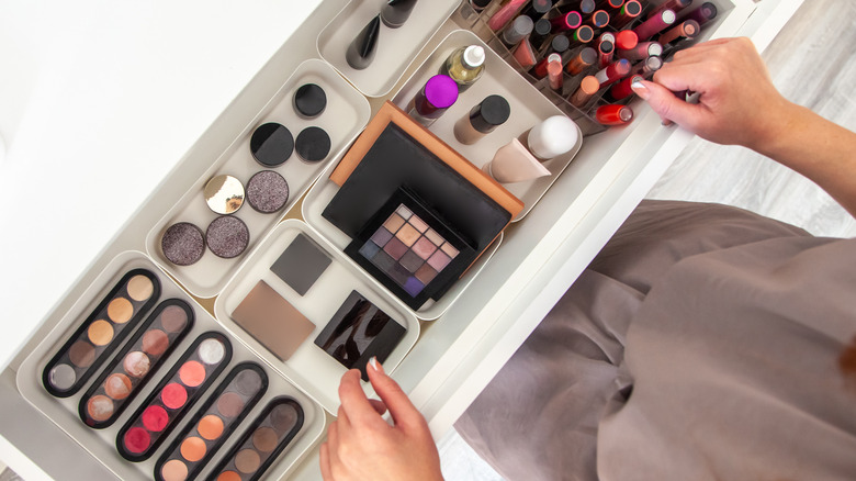 woman opening makeup drawer