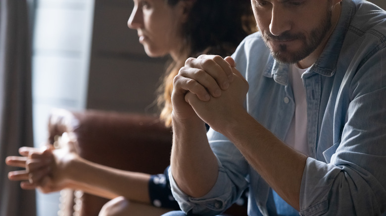 man and woman looking worried