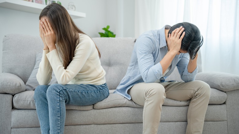 unhappy couple on a couch