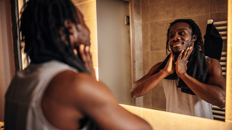 Man washing face in mirror