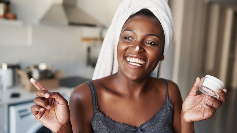 Woman applying skincare products 